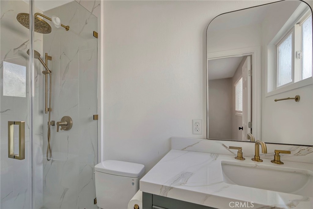 1115 South Groveland Place Anaheim, CA 92806 - Photo 28 of 42 a bathroom with a sink toilet and shower