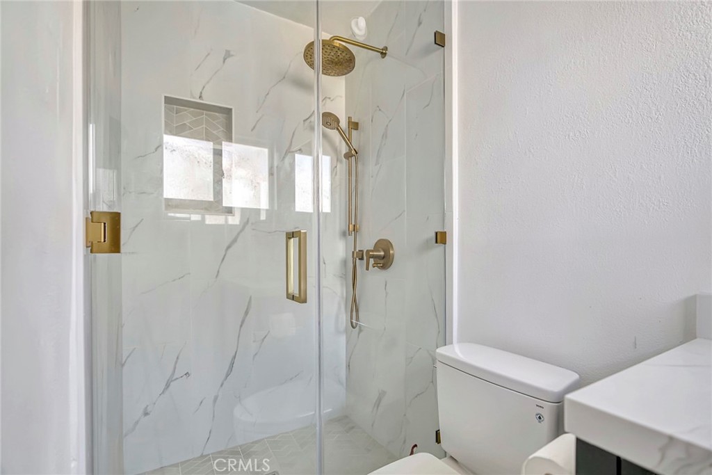 1115 South Groveland Place Anaheim, CA 92806 - Photo 29 of 42 a bathroom with a shower and toilet