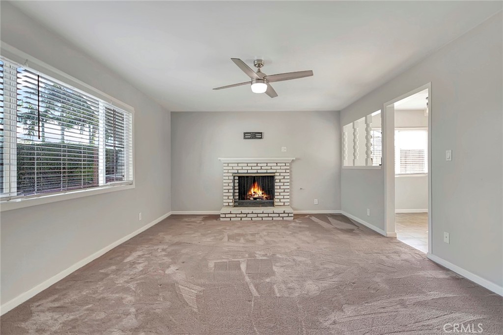 1115 South Groveland Place Anaheim, CA 92806 - Photo 7 of 42 an empty room with windows and fireplace