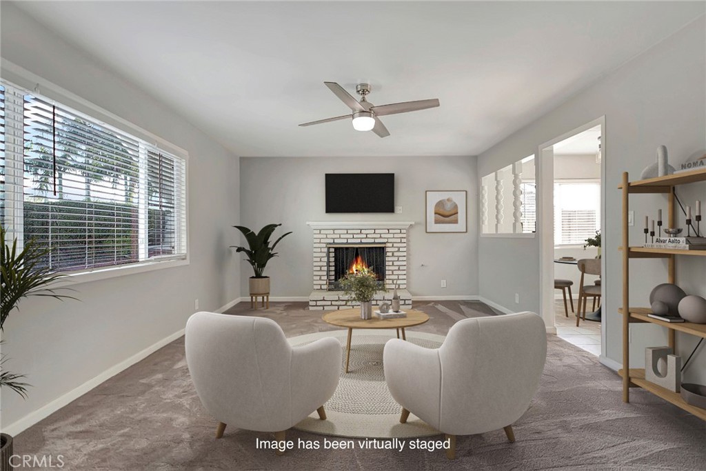 1115 South Groveland Place Anaheim, CA 92806 - Photo 8 of 42 a living room with furniture a fireplace and a flat screen tv