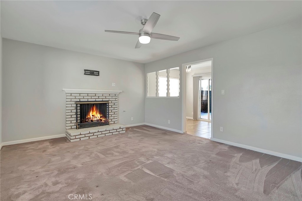 1115 South Groveland Place Anaheim, CA 92806 - Photo 9 of 42 a view of an empty room with chandelier fan and fireplace
