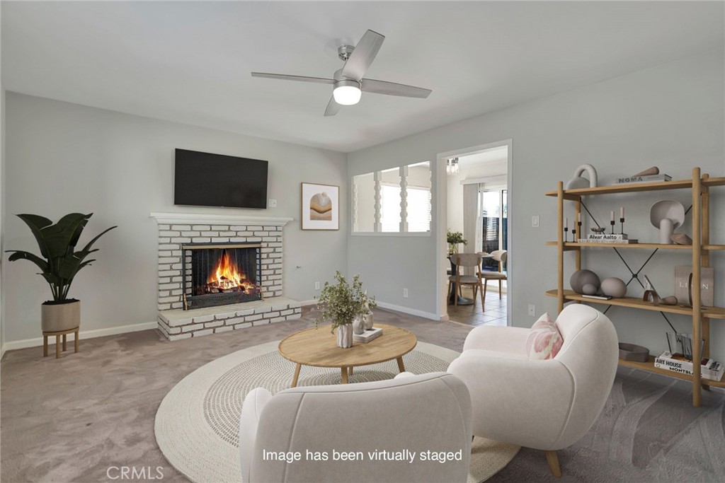 1115 South Groveland Place Anaheim, CA 92806 - Photo 10 of 42 a living room with furniture a fireplace and a flat screen tv