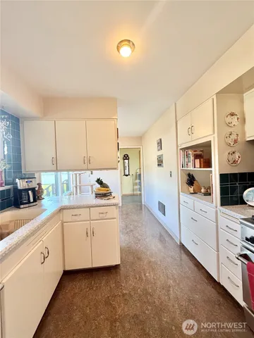 a kitchen with stainless steel appliances granite countertop a sink a stove and a refrigerator