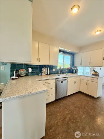 a kitchen that has a lot of cabinets in it and appliances
