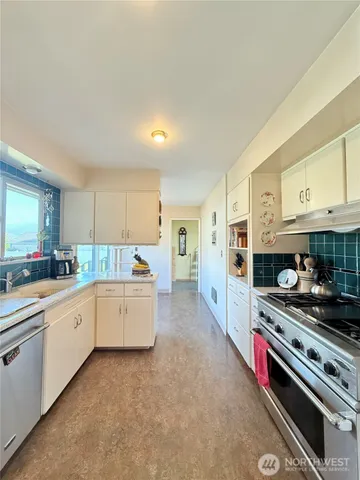 a living room with furniture and a kitchen view