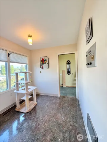 a bedroom with a bed and a painting on the wall