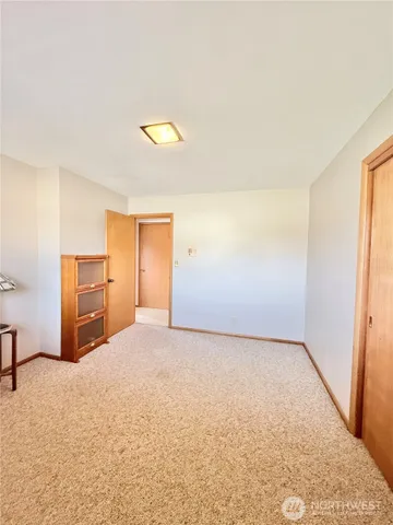 an empty room with windows and closet