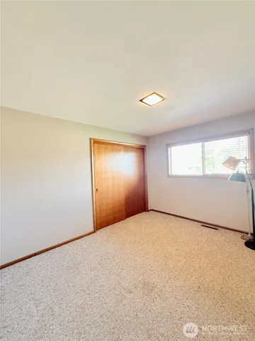 a large bedroom with a large bed and a couch