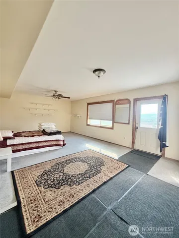 a view of a big yard with an house and wooden fence