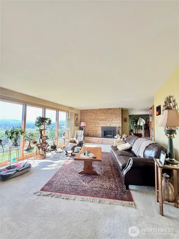 a living room with furniture and a floor to ceiling window