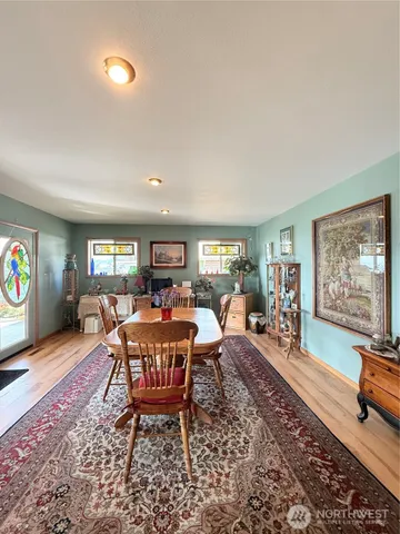 a living room with furniture a rug and a flat screen tv