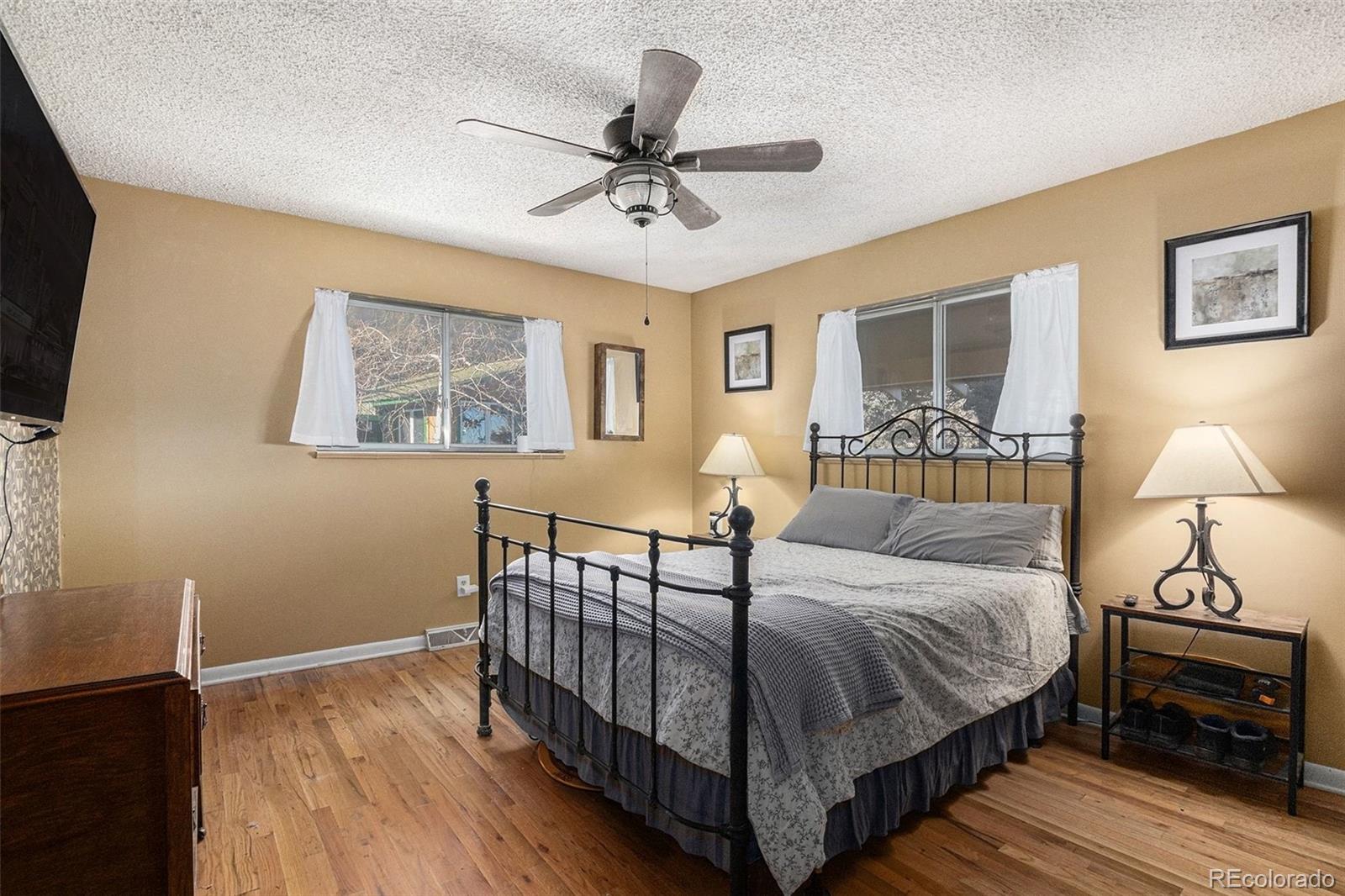 10148 South Turkey Creek Road Morrison, CO 80465 - Photo 16 of 50 a bedroom with a bed and a night stand