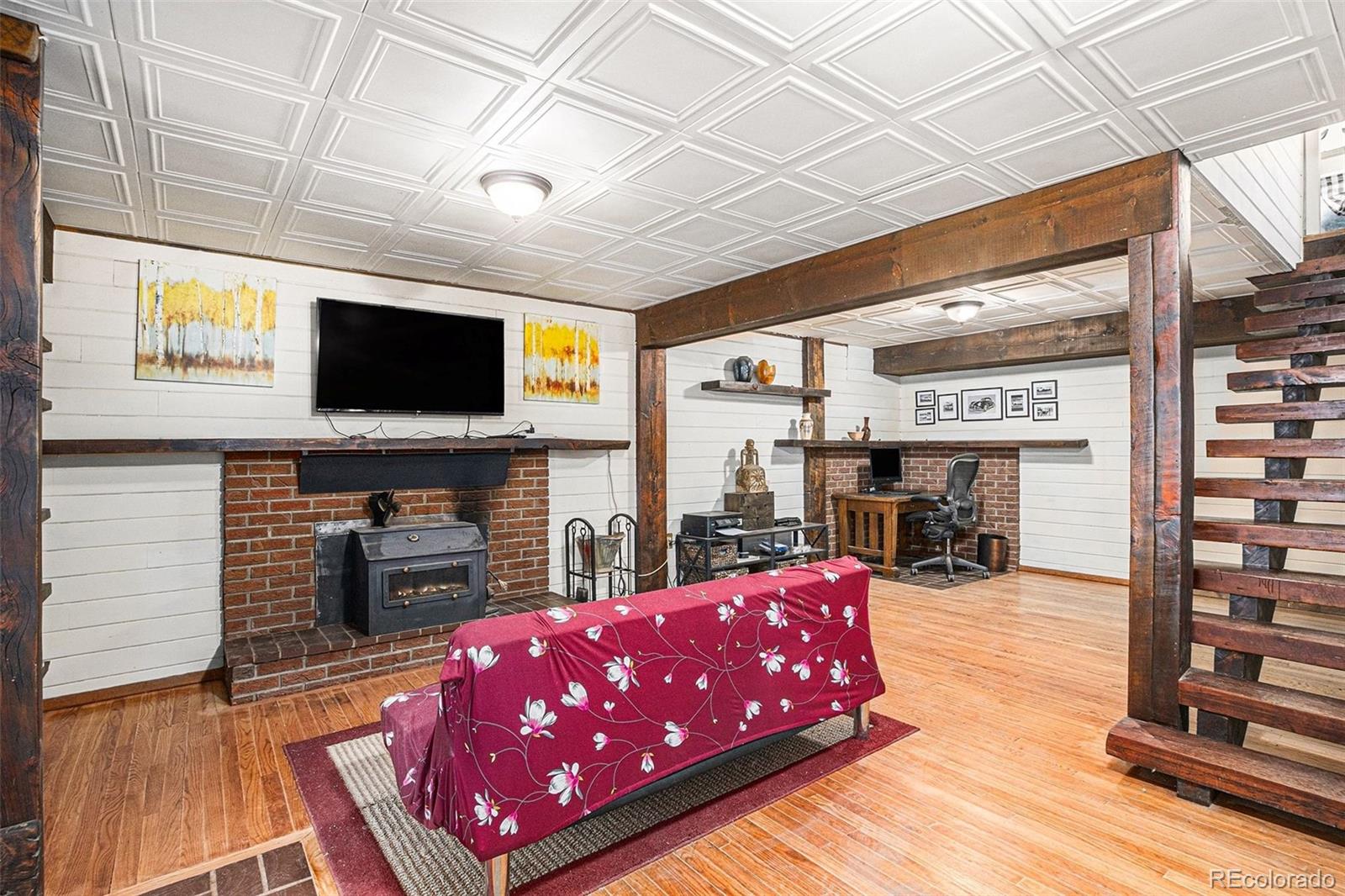 10148 South Turkey Creek Road Morrison, CO 80465 - Photo 20 of 50 a living room with furniture a flat screen tv and a fireplace