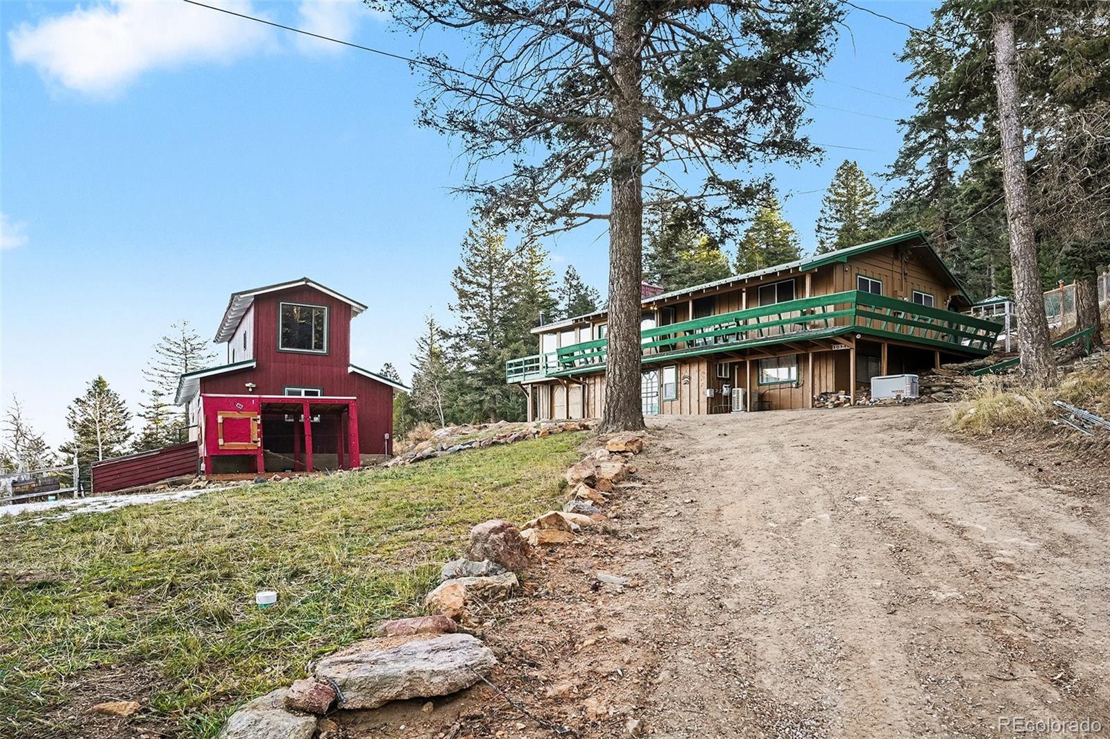 10148 South Turkey Creek Road Morrison, CO 80465 - Photo 2 of 50 a front view of a house with a yard