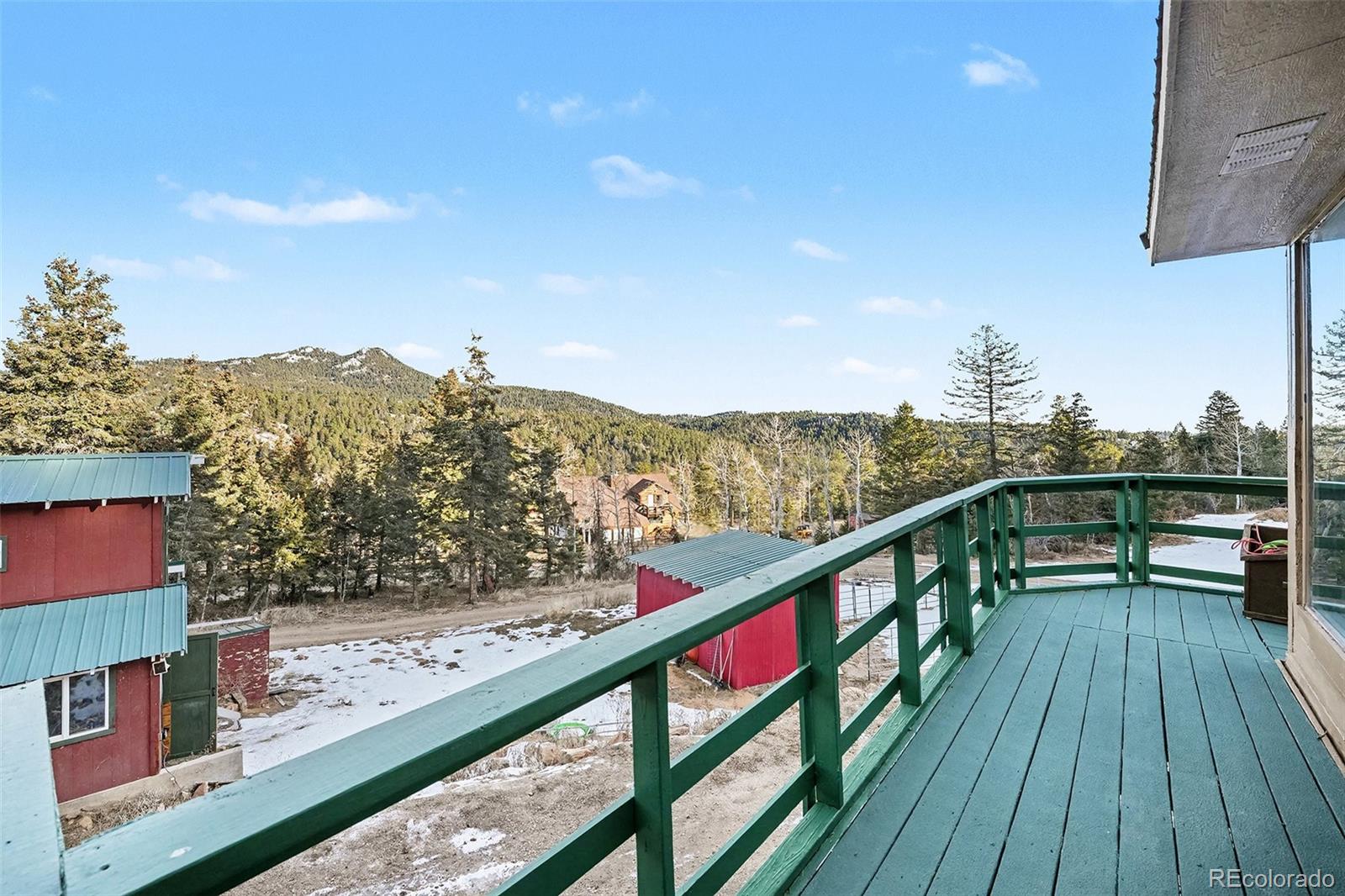 10148 South Turkey Creek Road Morrison, CO 80465 - Photo 24 of 50 a view of a balcony with wooden chairs and floor to ceiling window