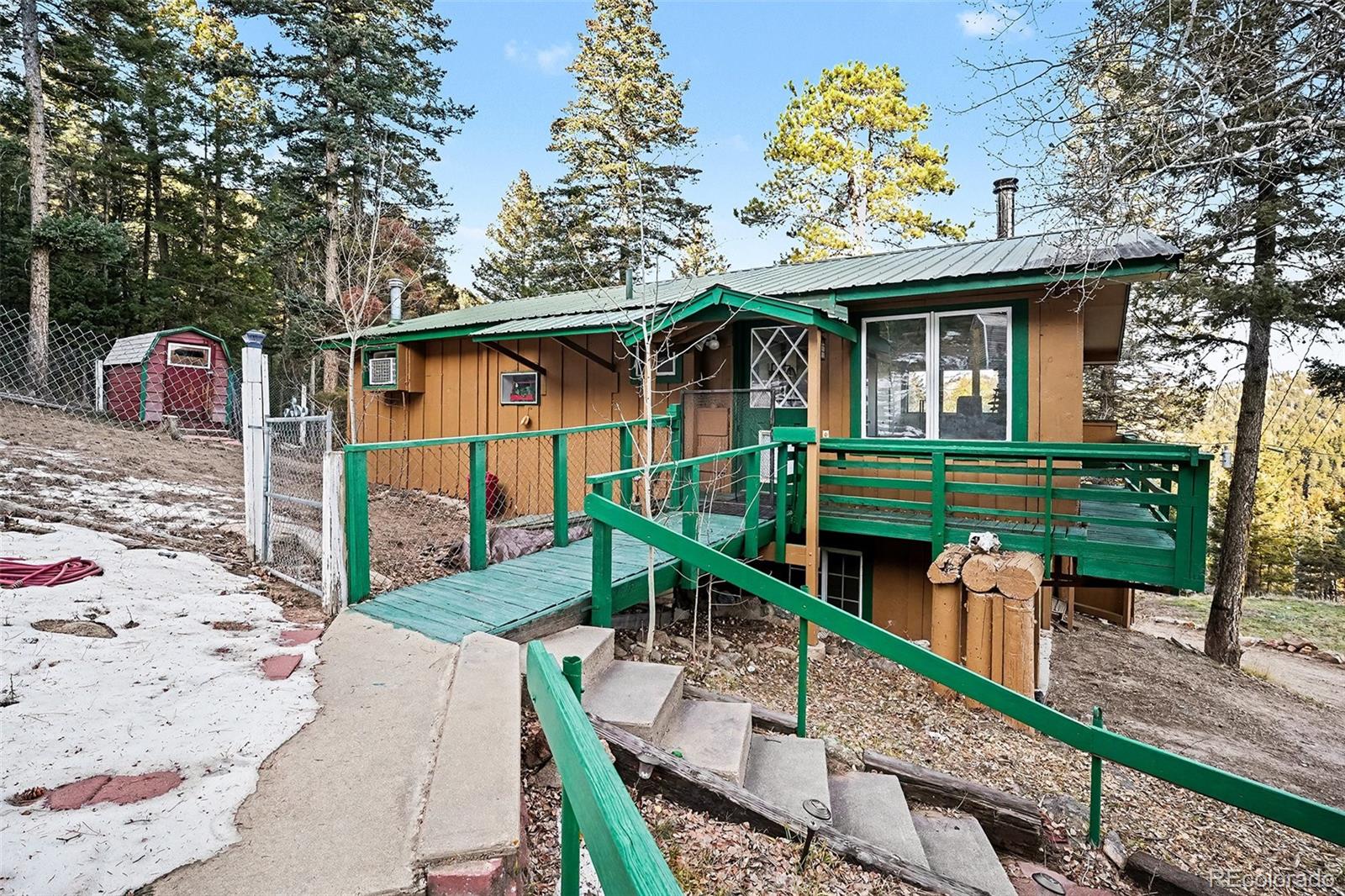10148 South Turkey Creek Road Morrison, CO 80465 - Photo 26 of 50 a front view of a house with garden