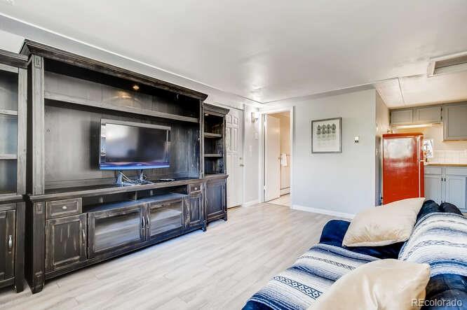 10148 South Turkey Creek Road Morrison, CO 80465 - Photo 30 of 50 a living room with furniture and a flat screen tv