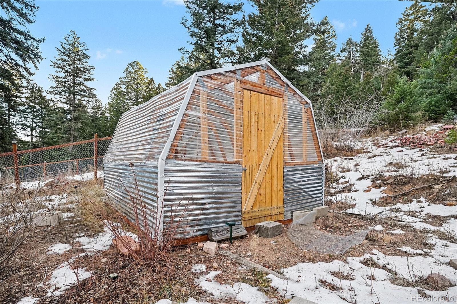 10148 South Turkey Creek Road Morrison, CO 80465 - Photo 39 of 50 a view of a house with a yard