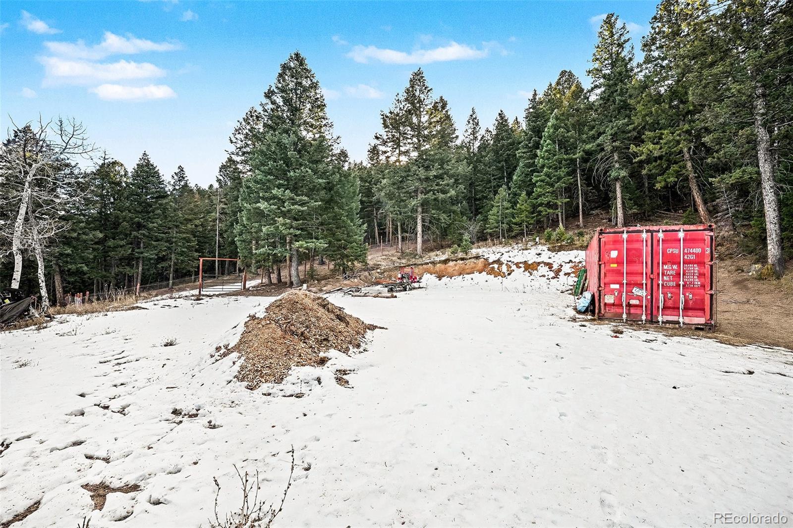 10148 South Turkey Creek Road Morrison, CO 80465 - Photo 43 of 50 a wooden bench sitting in the middle of a snow