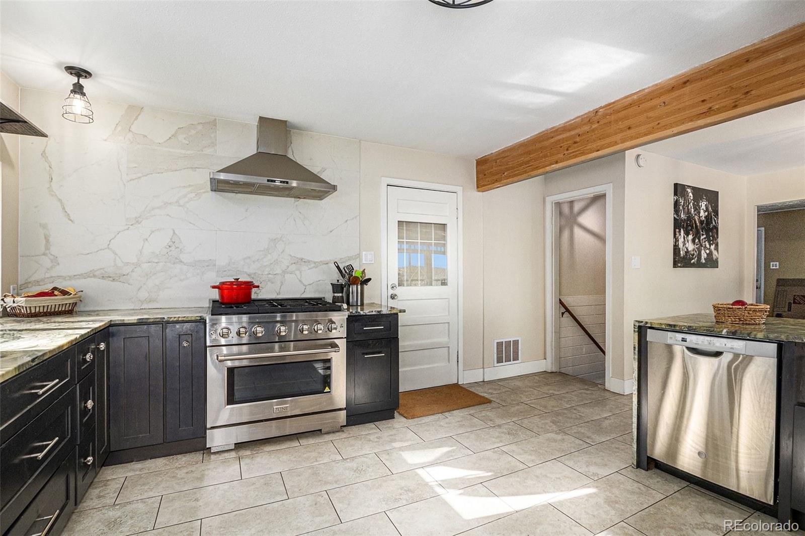 10148 South Turkey Creek Road Morrison, CO 80465 - Photo 7 of 50 a kitchen with stainless steel appliances granite countertop a stove a sink and a refrigerator