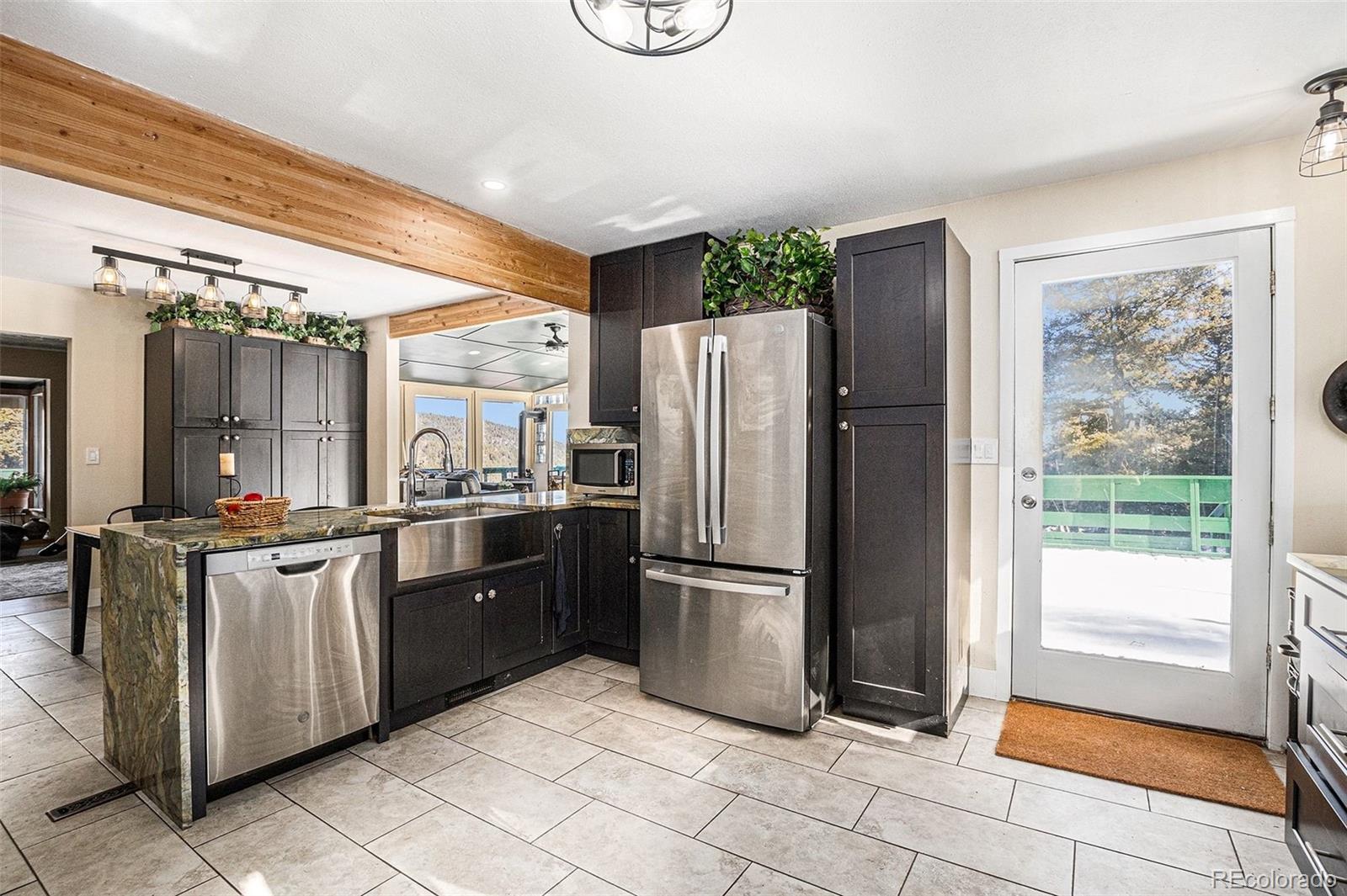 10148 South Turkey Creek Road Morrison, CO 80465 - Photo 9 of 50 a kitchen with stainless steel appliances granite countertop a refrigerator and a sink