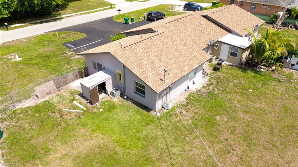 1940 48th Street Southwest Naples, FL 34116 - Photo 4 of 33 Single-story property featuring a tan shingle roof and light gray exterior siding