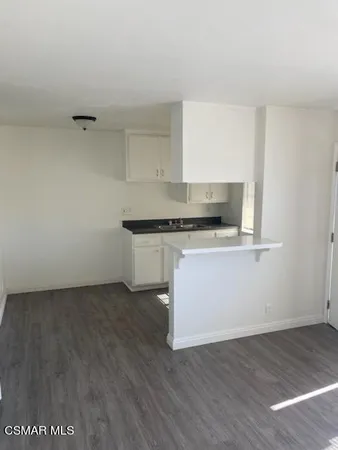 a kitchen with a sink window and cabinets