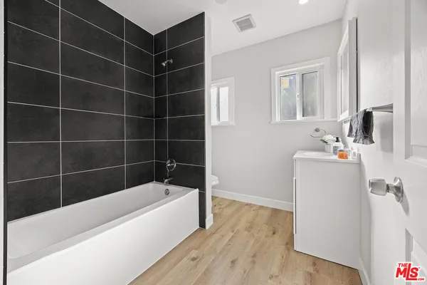 a bathroom with a bathtub and a sink