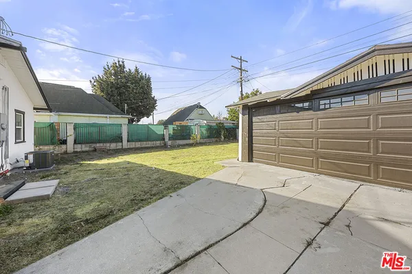 a view of a house with a backyard and a fountain