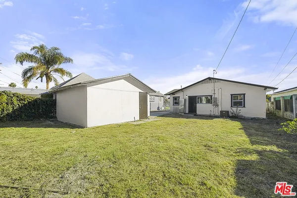 a yellow house with yard in front of it