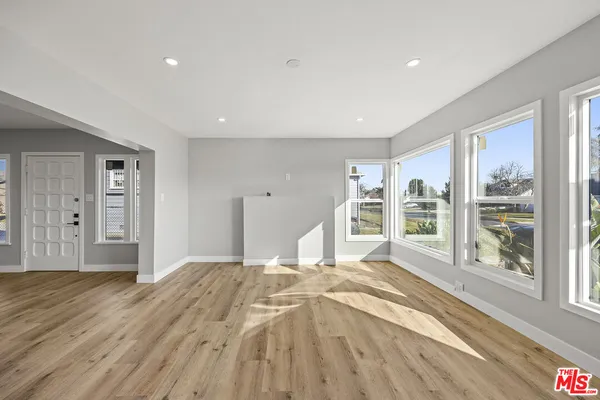 a spacious bedroom with a large bed and a large window