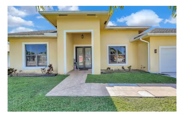 a kitchen with stainless steel appliances a refrigerator sink and cabinets