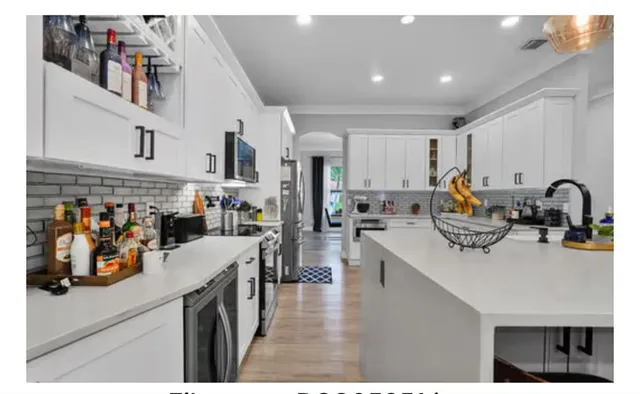 a bedroom with a bed and a view of living room