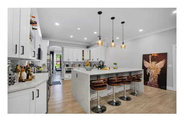 a bathroom with a sink a toilet a mirror and shower