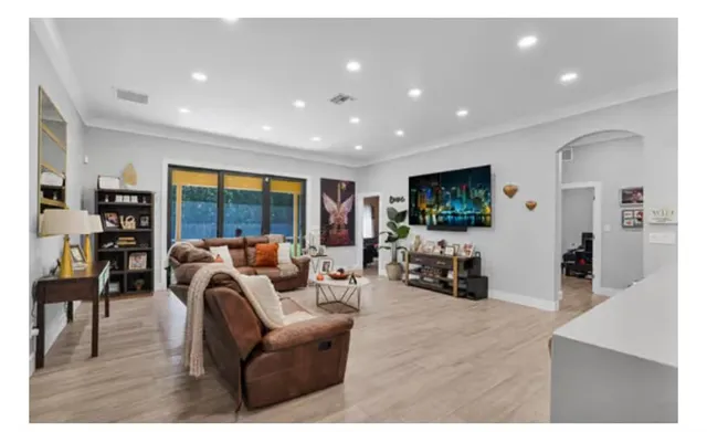 a bedroom with a bed and a flat tv screen on dresser