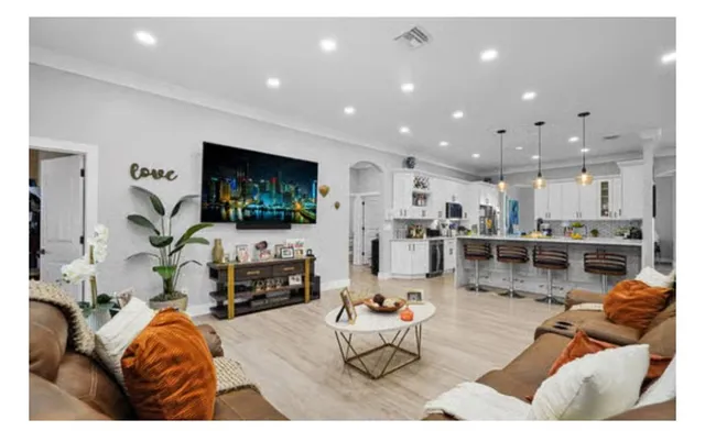 a living room with furniture and a dining area