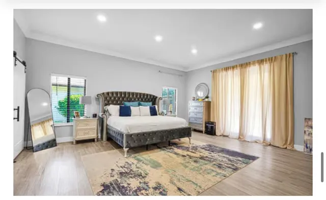 a living room with furniture and a painting on the wall