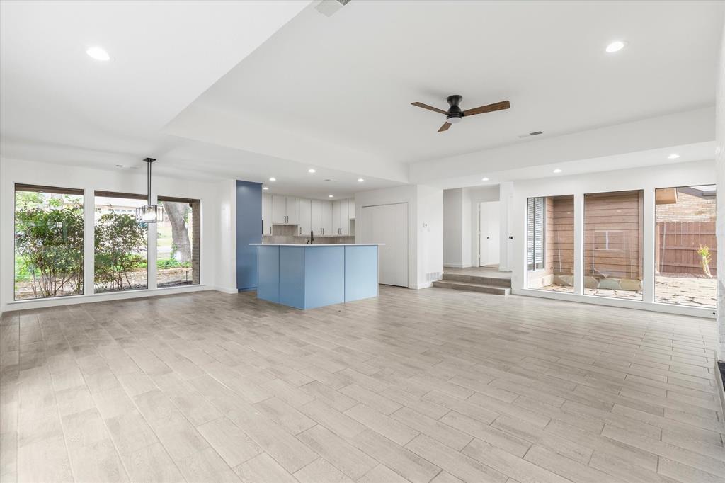 17003 Davenport Road Dallas, TX 75248 - Photo 10 of 40 an empty room with a kitchen view and windows