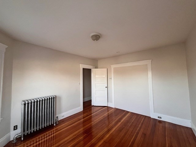81 Pleasant Street, Unit 3 Boston, MA 02125 - Photo 13 of 21 a view of a room with wooden floor and staircase