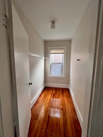 a view of a livingroom with wooden floor and window