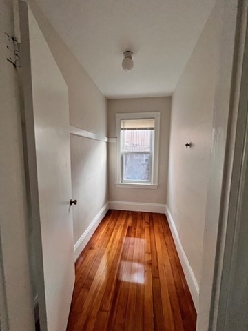 81 Pleasant Street, Unit 3 Boston, MA 02125 - Photo 15 of 21 a view of a livingroom with wooden floor and window