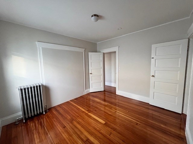 81 Pleasant Street, Unit 3 Boston, MA 02125 - Photo 17 of 21 a view of empty room with wooden floor