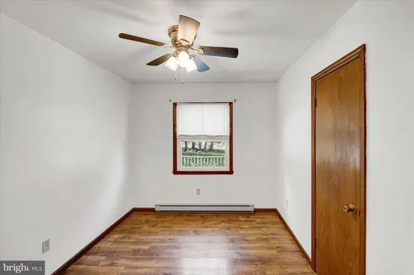 a view of a room with window and wooden floor