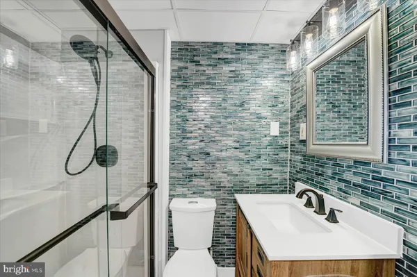 a bathroom with a sink toilet and shower