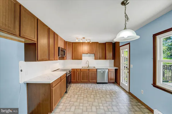 a kitchen with sink cabinets and window