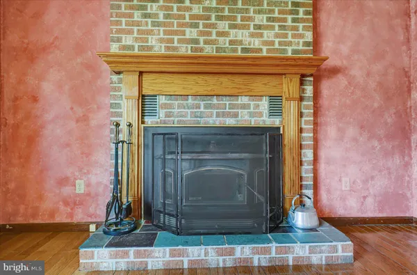 a view of fireplace with wooden floor