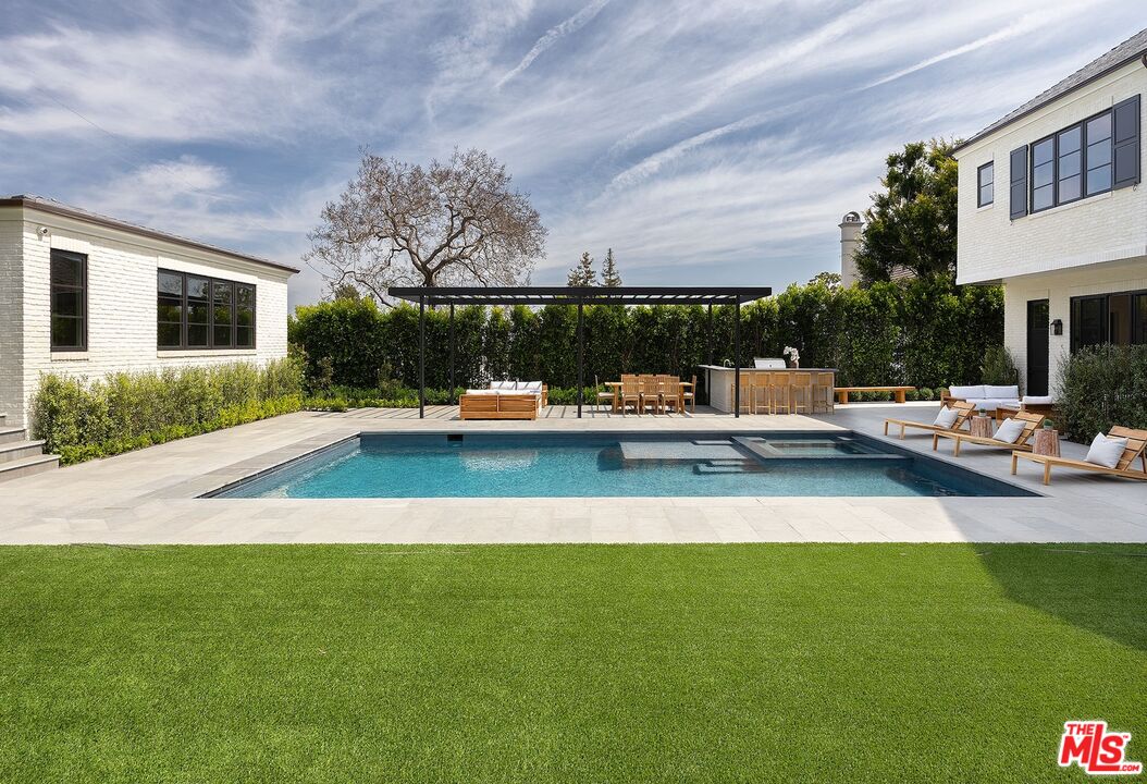 714 Alta Drive Beverly Hills, CA 90210 - Photo 12 of 29 a view of a swimming pool with a patio