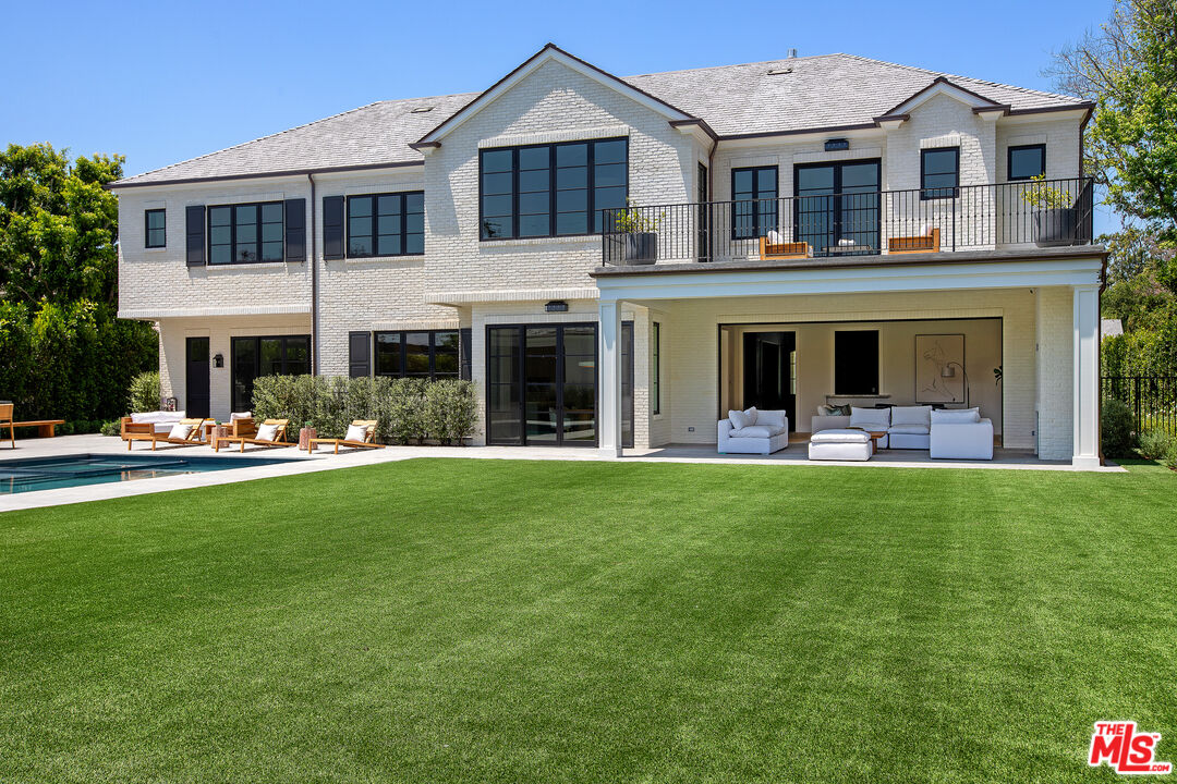 714 Alta Drive Beverly Hills, CA 90210 - Photo 13 of 29 a front view of a house with swimming pool and a garden