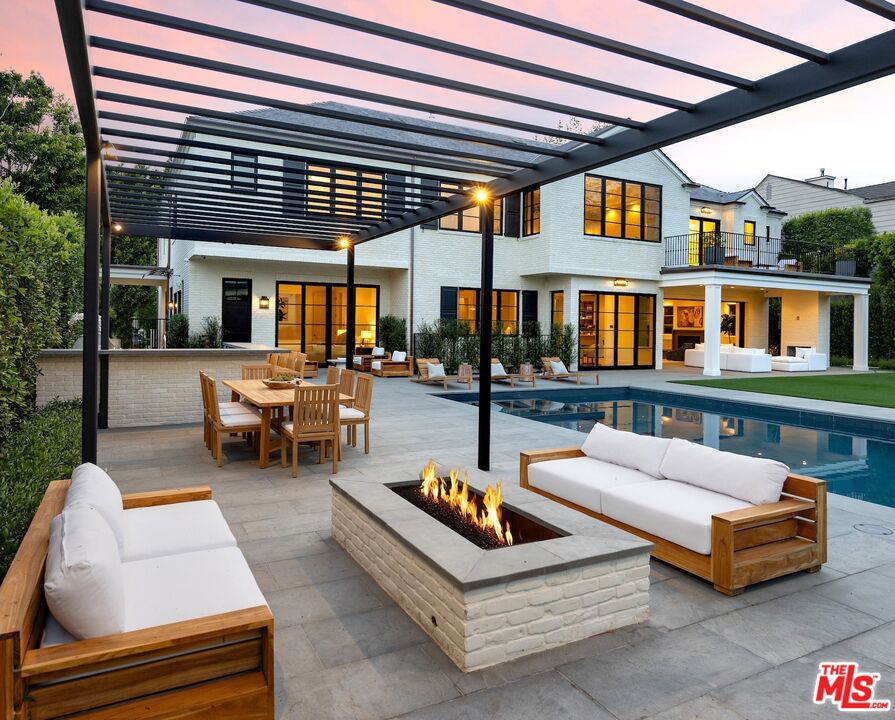 714 Alta Drive Beverly Hills, CA 90210 - Photo 3 of 29 a view of a patio with couches table and chairs and potted plants