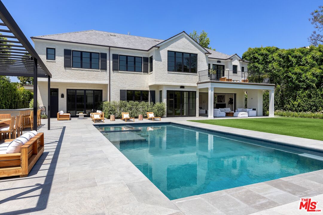 714 Alta Drive Beverly Hills, CA 90210 - Photo 6 of 29 a swimming pool view with a seating space and a garden view